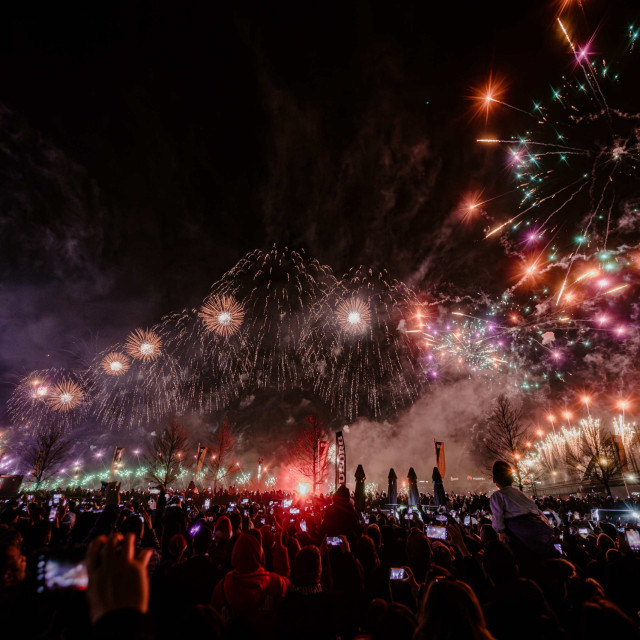 Visitors of the New Year's Eve celebration at Sava Promenada watch the fireworks