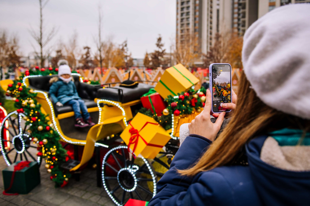 Mother takes a photo of a child