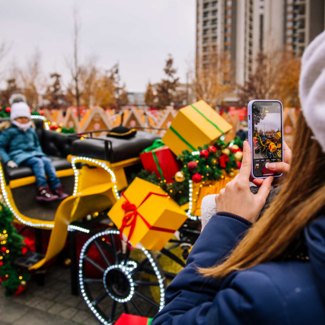 Mother takes a photo of a child