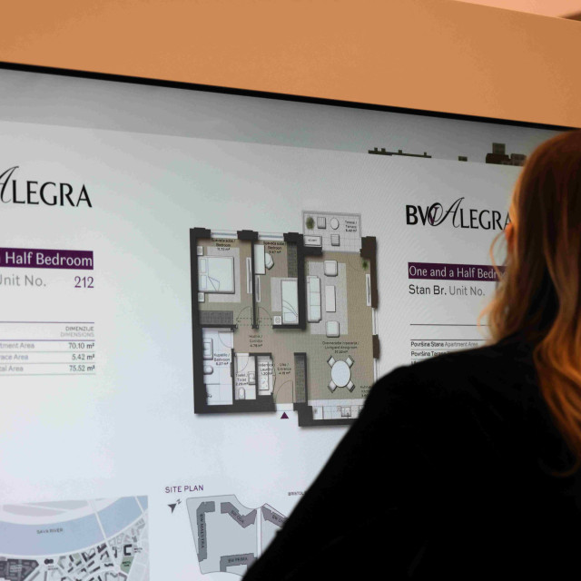 he customer looks at the floor plan of the BW Alegra building