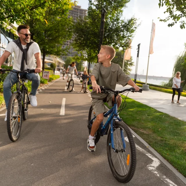 Father and son ride a bicycle through Belgrade Waterfront.